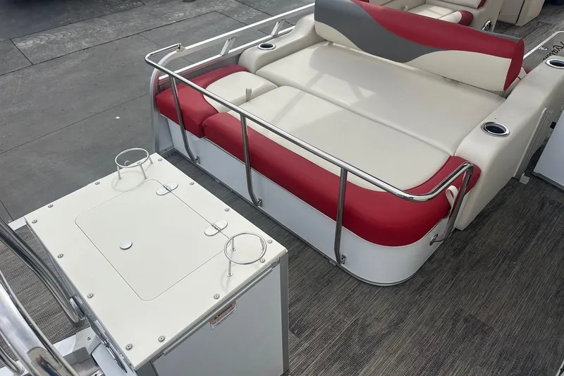 Slide: The Image of 2024 Avalon LSZ 2385 VRB boat interior with red and white seating and cup holders. - 18