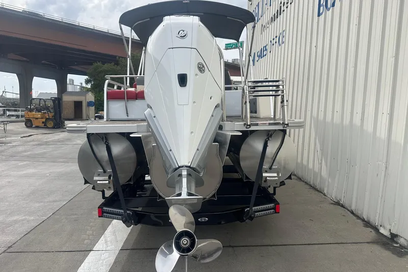 Slide: The Image of 2024 Avalon LSZ 2385 VRB pontoon boat rear view with outboard motor. - 2