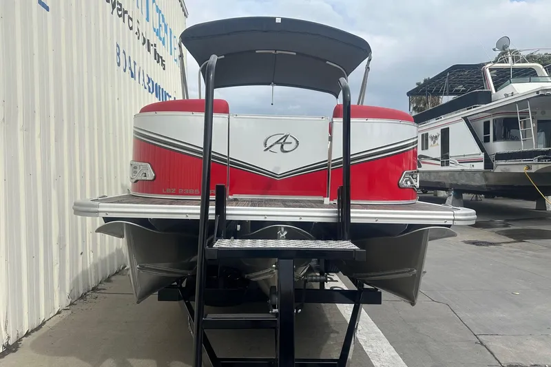 Slide: The Image of 2024 Avalon LSZ 2385 VRB pontoon boat, red and white, docked at marina. - 5