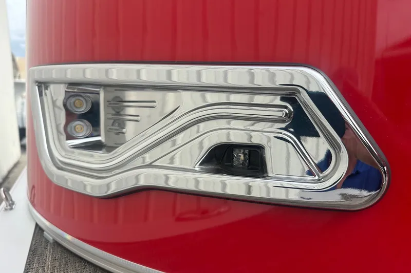 Slide: The Image of Close-up of 2024 Avalon LSZ 2385 VRB boat's sleek red and chrome detailing. - 6