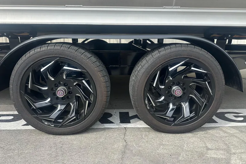 Slide: The Image of 2024 Avalon LSZ 2385 VRB with sleek black alloy wheels in a parking area. - 9