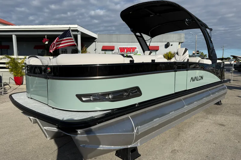 The Image of 2026 Avalon 2385 Catalina Quad Lounger Tri Toon, high-performance pontoon boat with American flag. - 0