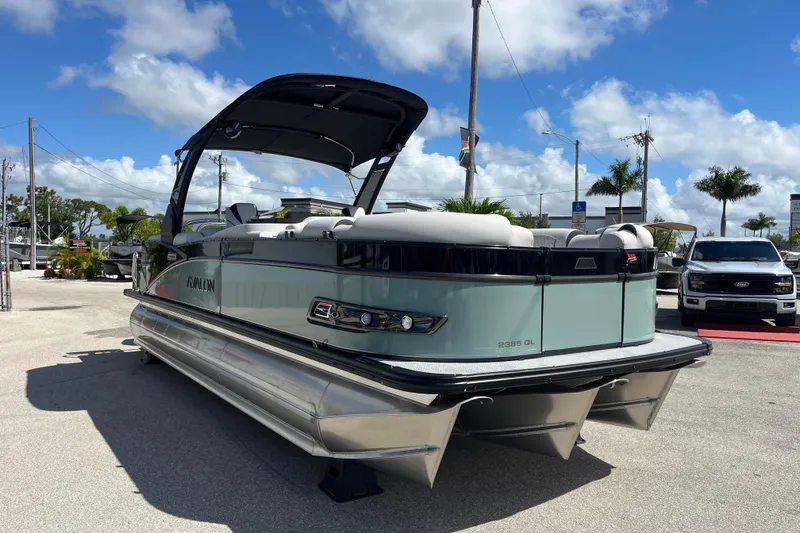 Slide: The Image of 2026 Avalon 2385 Catalina Quad Lounger, Tri Toon High Performance boat in a sunny outdoor setting. - 4