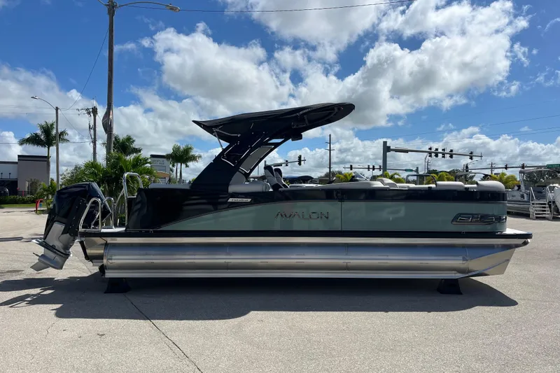 Slide: The Image of 2026 Avalon 2385 Catalina Quad Lounger Tri Toon boat in a sunny outdoor setting. - 5