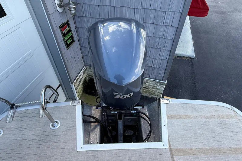 Slide: The Image of 2016 Bennington 2550 RSF Arch Tri Toon with Yamaha 300 engine, docked near a building. - 12