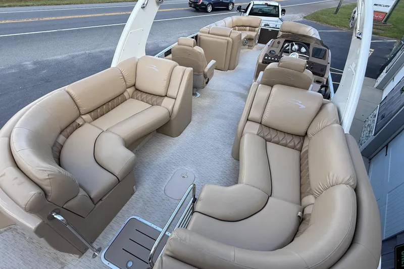 Slide: The Image of 2016 Bennington 2550 RSF Arch Tri Toon with luxurious beige seating and modern dashboard. - 14