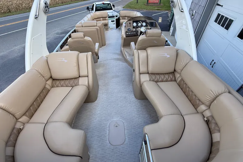 Slide: The Image of 2016 Bennington 2550 RSF Arch Tri Toon with luxurious beige seating and modern dashboard. - 15
