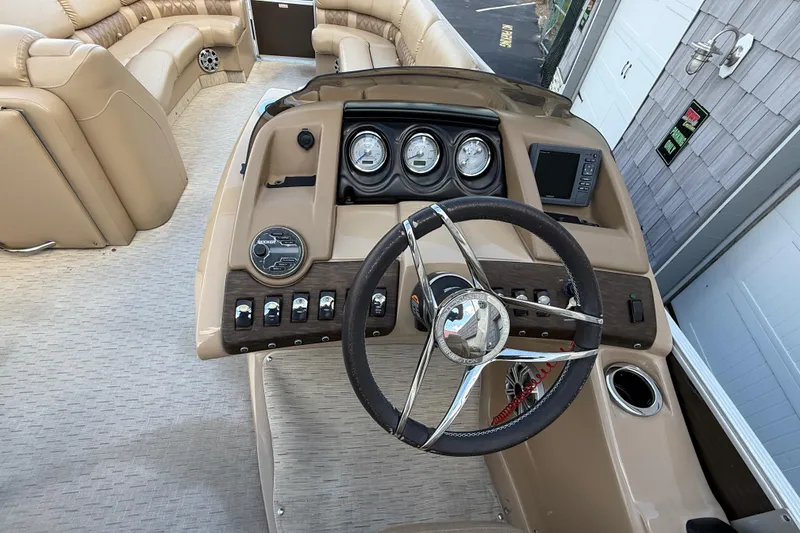 Slide: The Image of 2016 Bennington 2550 RSF Arch Tri Toon boat dashboard with steering wheel and gauges. - 19