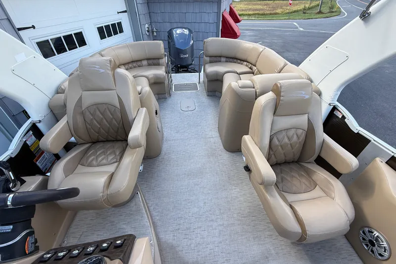 Slide: The Image of 2016 Bennington 2550 RSF Arch Tri Toon interior with luxurious beige seating. - 24