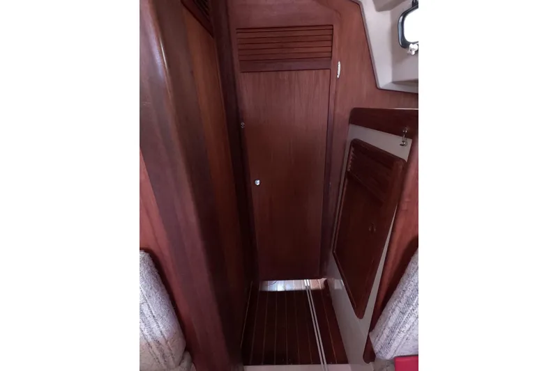 Slide: The Image of Interior of 1985 Mirage 35 sailboat with wooden cabinetry and compact design. - 11