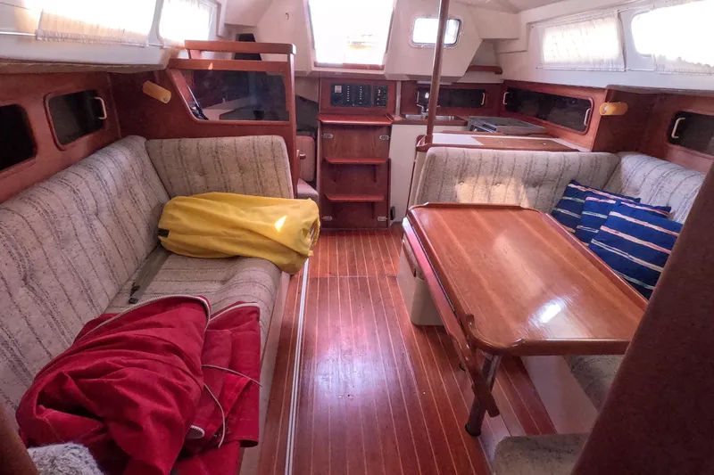Slide: The Image of Interior of 1985 Mirage 35 sailboat with cozy seating and wooden table. - 12
