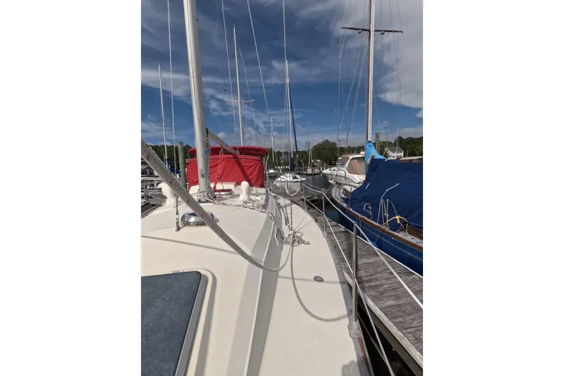Slide: The Image of Sailboat Mirage 35, 1985 model, docked at marina with clear sky. - 19