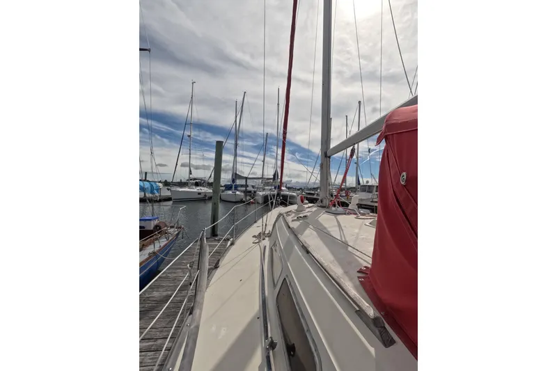 Slide: The Image of 1985 Mirage 35 sailboat docked at marina under cloudy sky. - 20
