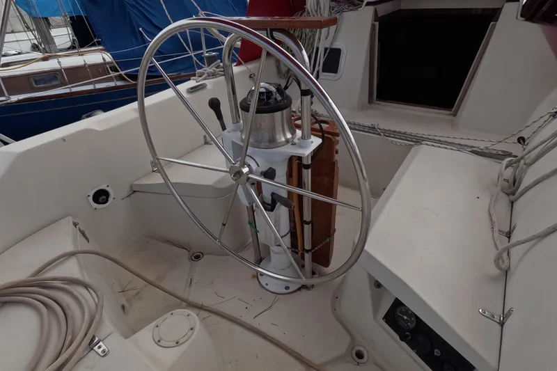 Slide: The Image of Steering wheel of a 1985 Mirage 35 sailboat in the cockpit area. - 4