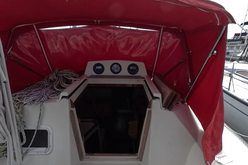 Slide: The Image of 1985 Mirage 35 sailboat cockpit with red canopy and nautical ropes. - 5