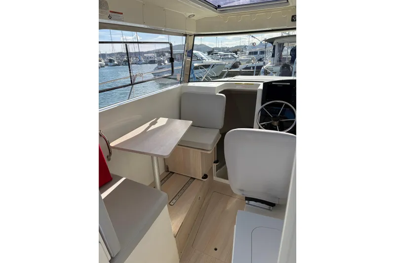 Slide: The Image of Interior of 2023 Bayliner Trophy T25 Pilothouse with seating and steering wheel. - 3