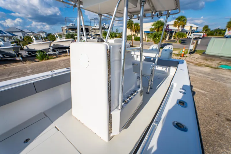 Slide: The Image of 1997 Contender 27 boat interior with console, parked outdoors under a blue sky. - 18