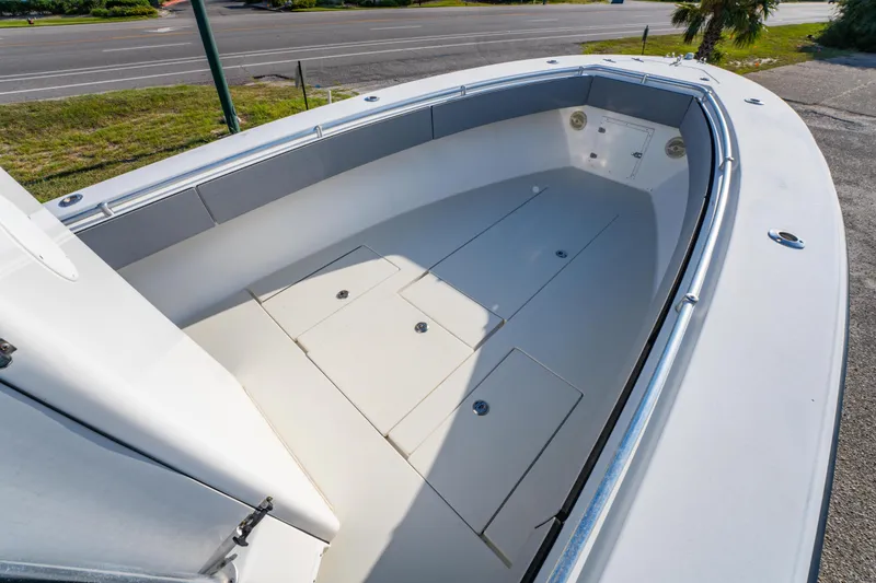 Slide: The Image of 1997 Contender 27 boat interior with spacious deck and storage compartments. - 21