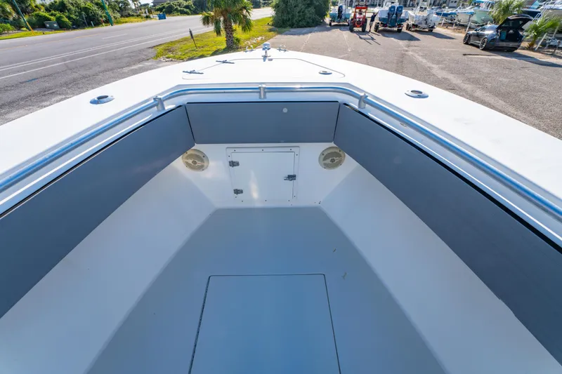 Slide: The Image of 1997 Contender 27 boat interior with storage compartment and speakers, parked near a road. - 22