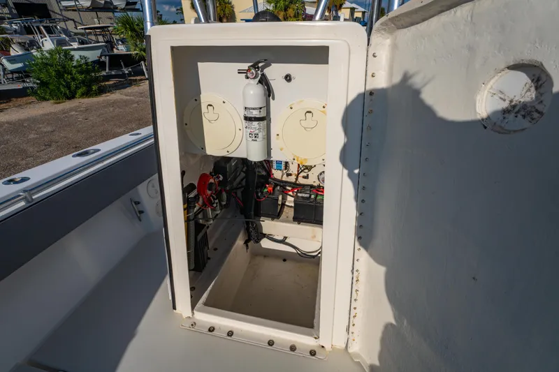 Slide: The Image of 1997 Contender 27 boat interior showing electrical components and fire extinguisher. - 24