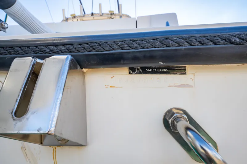 Slide: The Image of Close-up of a 1997 Contender 27 boat's metal fittings and rope detail. - 28