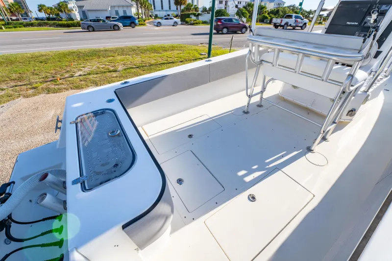 Slide: The Image of 1997 Contender 27 boat deck with seating and storage compartments. - 9