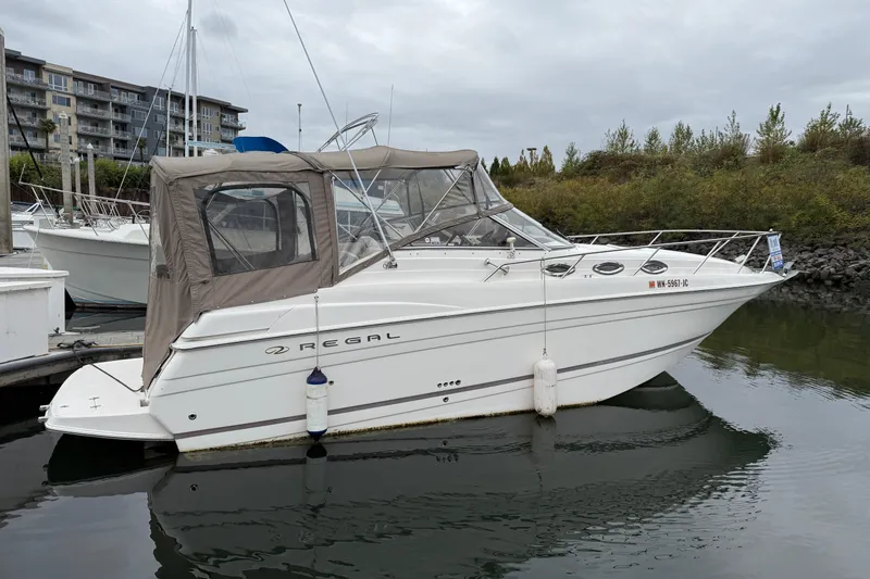 The Image of 2004 Regal Commodore 2765 boat docked in a marina, overcast sky. - 0