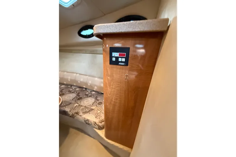 Slide: The Image of Interior of 2004 Regal Commodore 2765 boat with control panel and patterned seating. - 11