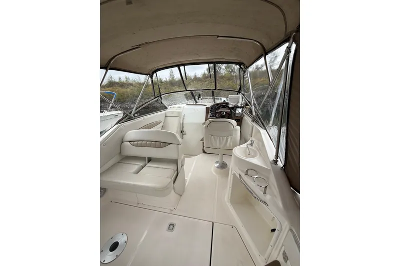 Slide: The Image of 2004 Regal Commodore 2765 boat interior with seating, helm, and canopy. - 3