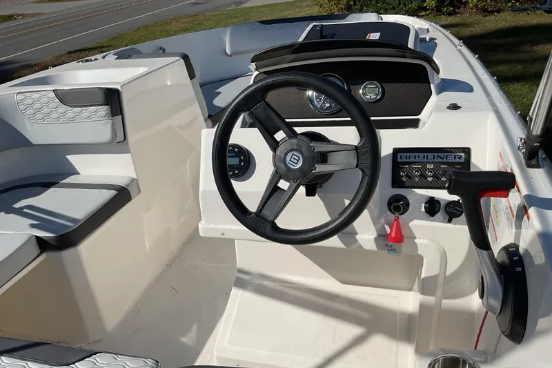 Slide: The Image of 2022 Bayliner Element M17 boat cockpit with steering wheel and control panel. - 10