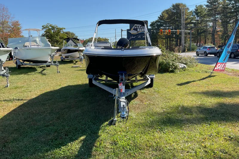 Slide: The Image of 2022 Bayliner Element M17 boat on display outdoors, surrounded by other boats. - 3