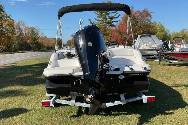 Slide: The Image of 2022 Bayliner Element M17 boat on trailer, parked on grass with autumn trees. - 7
