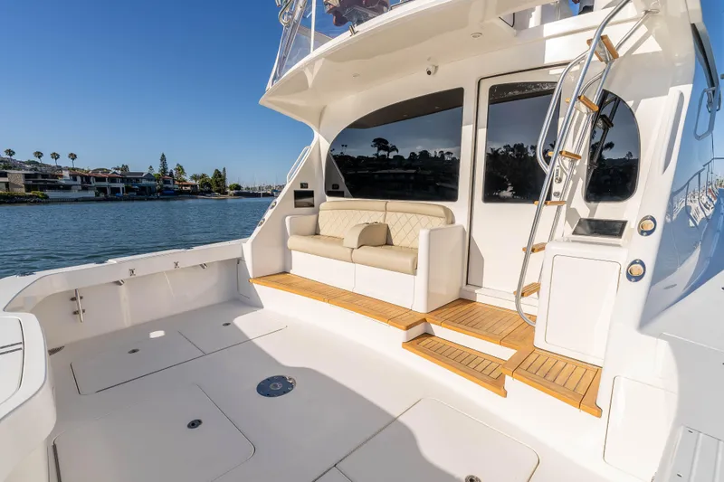 Slide: The Image of Luxurious 2014 Viking 46 Convertible yacht with spacious deck and elegant seating area. - 11