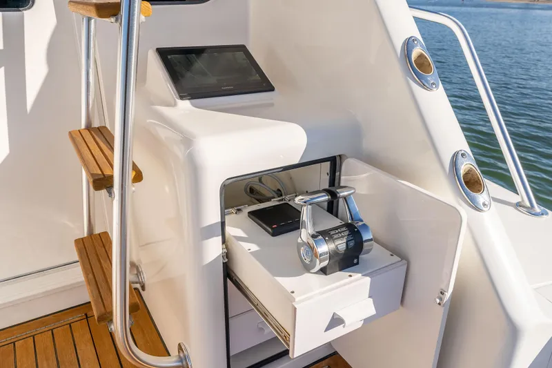 Slide: The Image of Control panel of 2014 Viking 46 Convertible yacht with wooden steps and water view. - 12