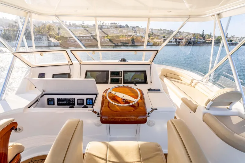 Slide: The Image of 2014 Viking 46 Convertible yacht helm with modern controls and panoramic water view. - 14