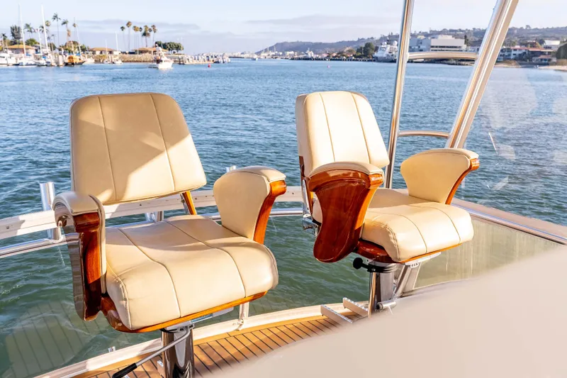 Slide: The Image of Luxurious seating on 2014 Viking 46 Convertible yacht, overlooking scenic marina view. - 17