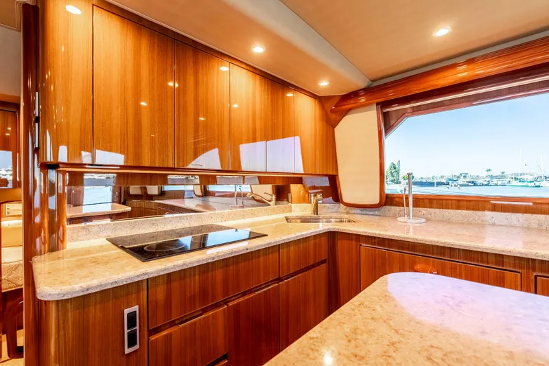 Slide: The Image of Luxurious kitchen interior of 2014 Viking 46 Convertible yacht with wood cabinetry and ocean view. - 23