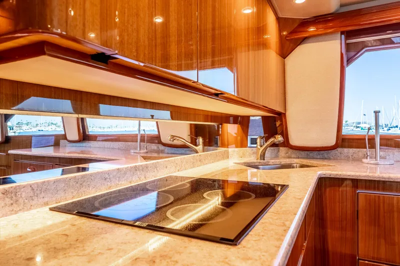 Slide: The Image of Luxurious kitchen interior of 2014 Viking 46 Convertible yacht with modern appliances and wood finish. - 24