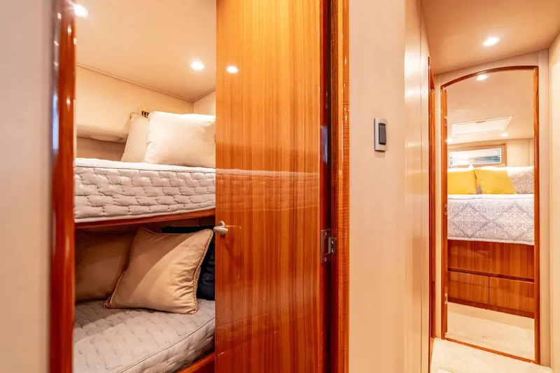 Slide: The Image of Interior of 2014 Viking 46 Convertible yacht with cozy bunk beds and elegant wood finish. - 27