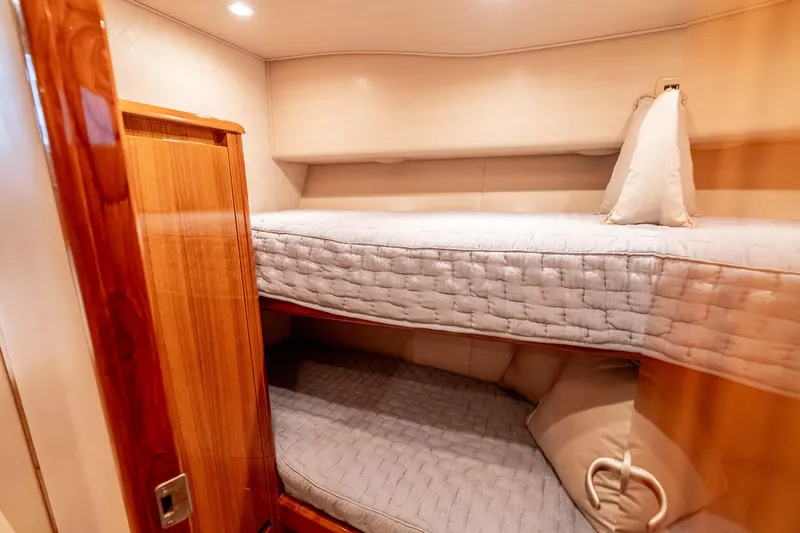 Slide: The Image of 2014 Viking 46 Convertible yacht interior with cozy bunk beds and wooden finishes. - 28
