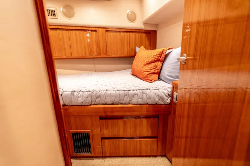 Slide: The Image of Luxurious cabin interior of 2014 Viking 46 Convertible yacht with cozy bedding and wooden finishes. - 29