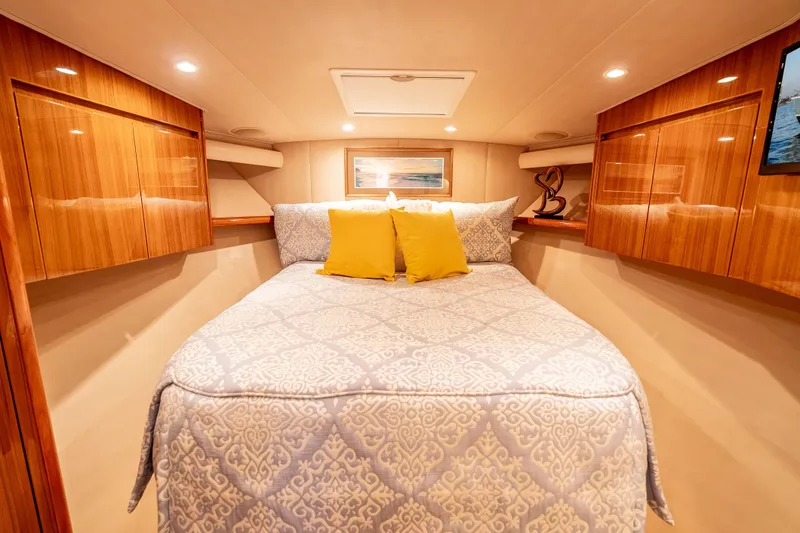 Slide: The Image of Luxurious cabin interior of 2014 Viking 46 Convertible yacht with elegant bedding and wood finishes. - 33