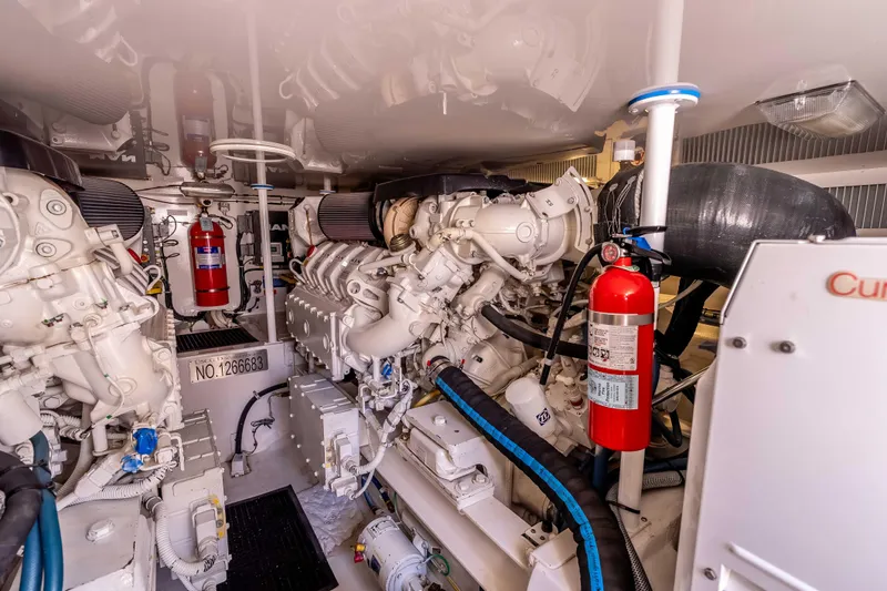 Slide: The Image of Engine room of 2014 Viking 46 Convertible yacht, featuring dual engines and fire extinguishers. - 38