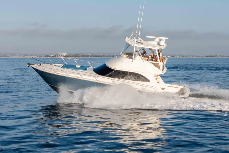 Slide: The Image of 2014 Viking 46 Convertible yacht cruising on open water. - 6