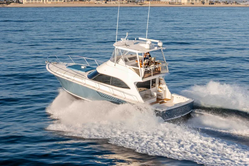 Slide: The Image of 2014 Viking 46 Convertible yacht cruising on open water. - 7