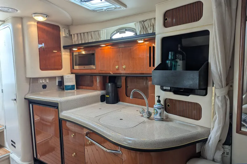 Slide: The Image of Luxurious 2001 Sea Ray 340 Sundancer yacht interior with modern kitchen amenities. - 13