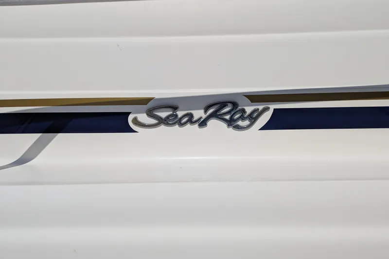 Slide: The Image of 2001 Sea Ray 340 Sundancer logo on white boat exterior. - 22