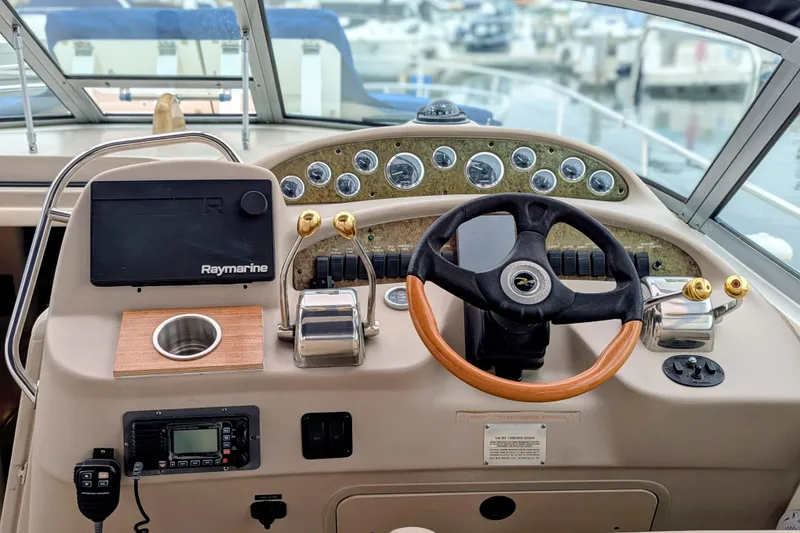Slide: The Image of 2001 Sea Ray 340 Sundancer helm with steering wheel and control panel. - 3