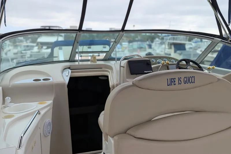 Slide: The Image of Interior of a 2001 Sea Ray 340 Sundancer boat with "Life is Gucci" on seat. - 5