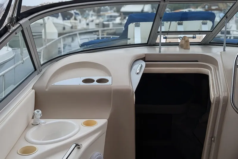 Slide: The Image of 2001 Sea Ray 340 Sundancer interior with sink and cup holders, docked at marina. - 6
